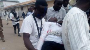 IMN supporters hold the dead body of a fellow demonstrator who was shot and critically injured by Nigerian police during a religious procession in the northern town of Zaria on November 14, 2019